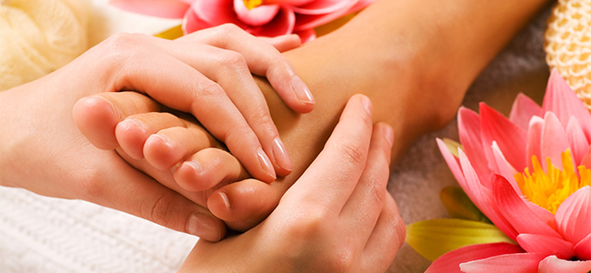 masseur doing massage at one foot